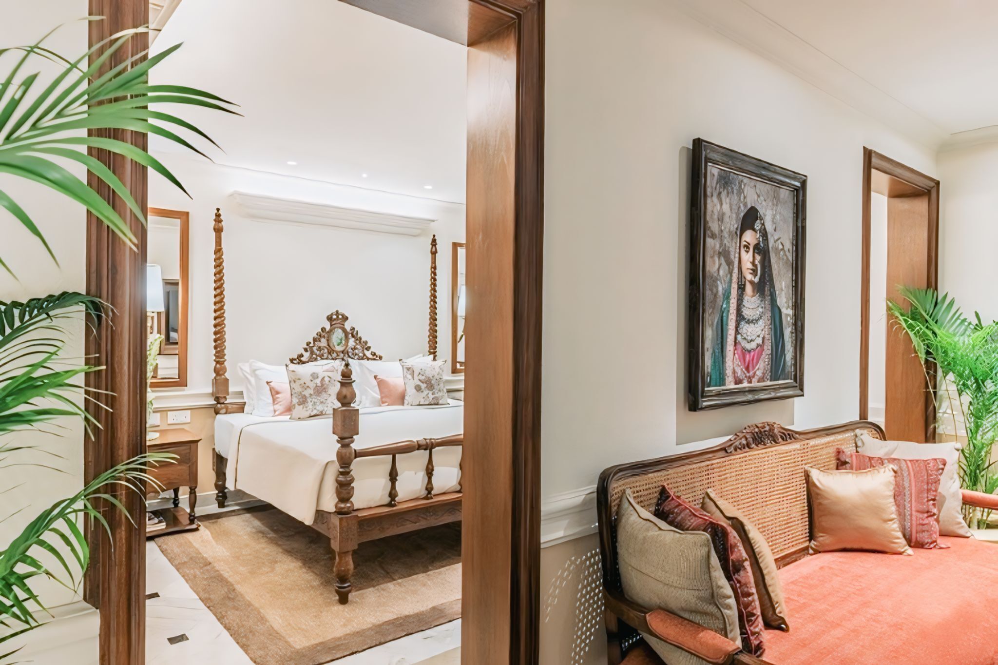 A bedroom with a four-poster bed, a wooden headboard, and a large framed picture on the wall.