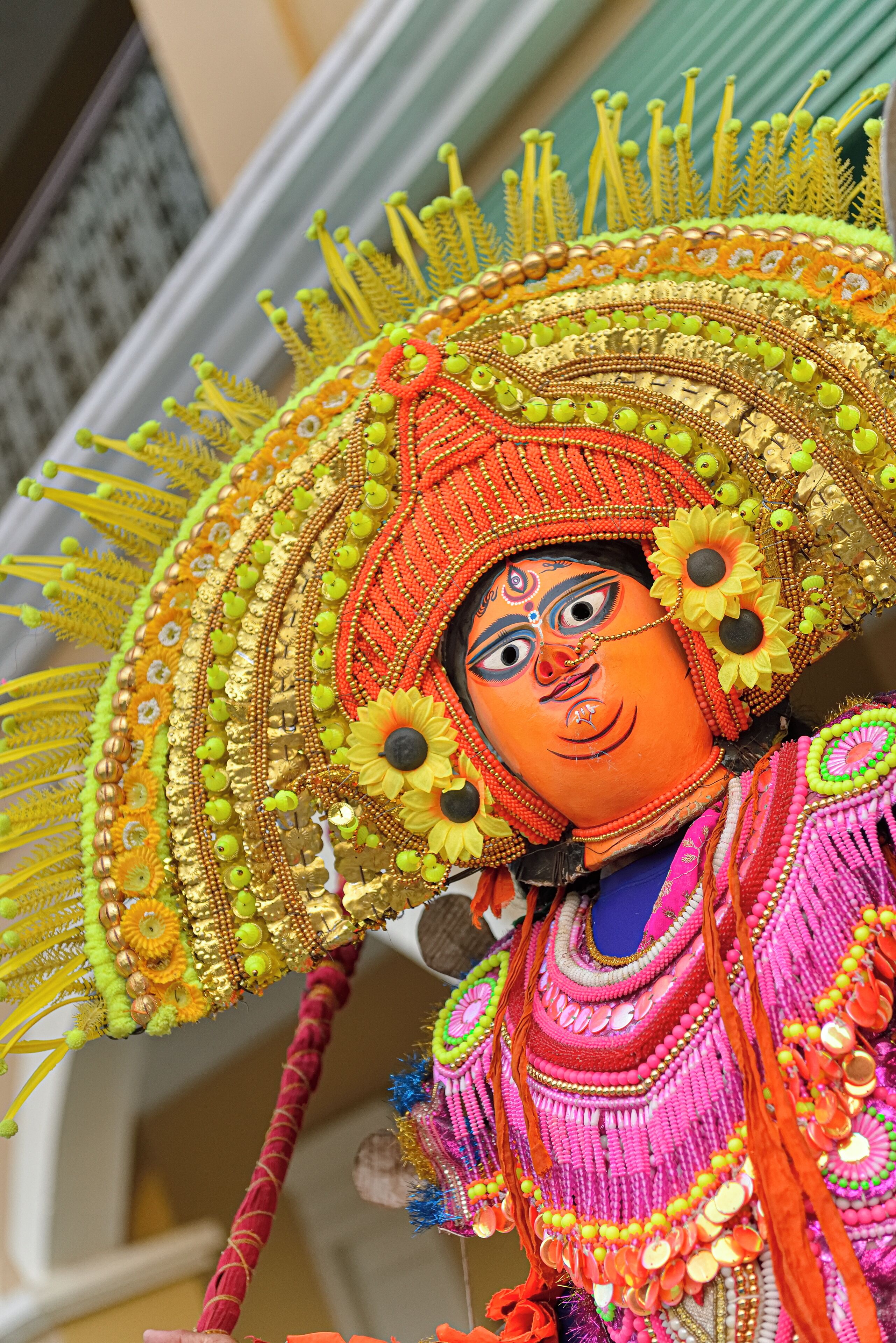 A colorful, ornate headpiece with a large fan and decorative elements.