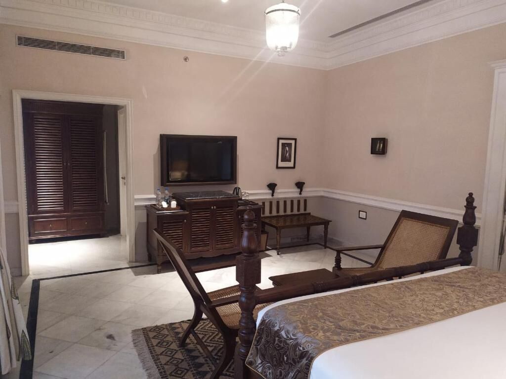 Une chambre à coucher avec un lit, une télévision, un bureau et une chaise.