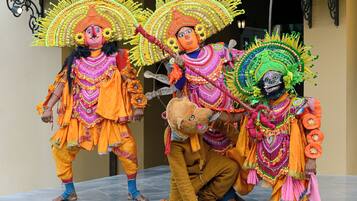 A group of performers in traditional costumes with elaborate headdresses.