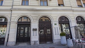 A multi-story building with arched windows and a central entrance. - Filip Palace Luxurious Apartment (Ljubljana)