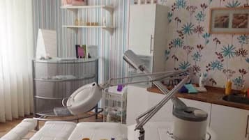 Guest rooms feature a bed, examination table, and medical equipment, along with personal touches and a unique wallpaper design.