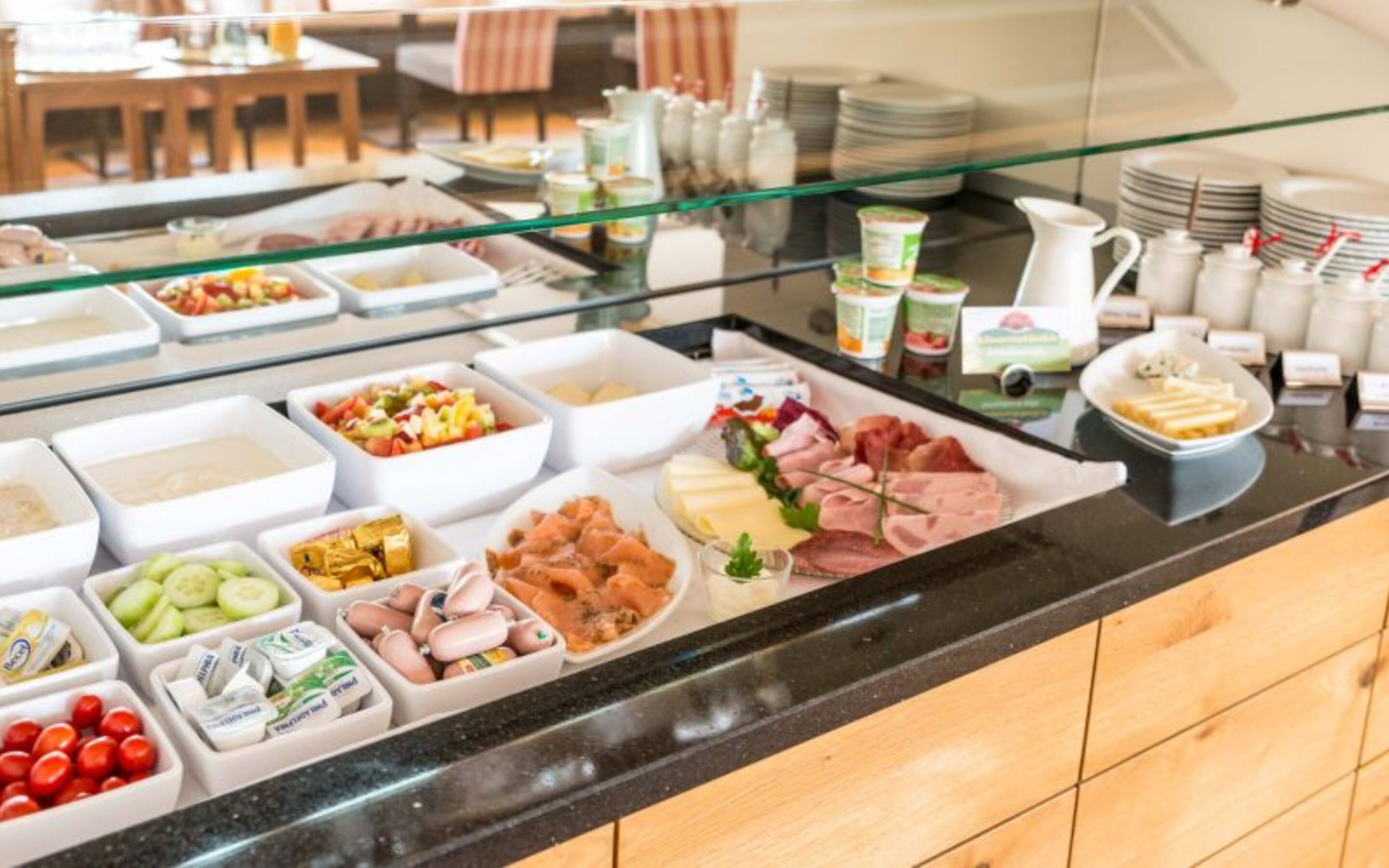 A buffet with various food items and condiments.