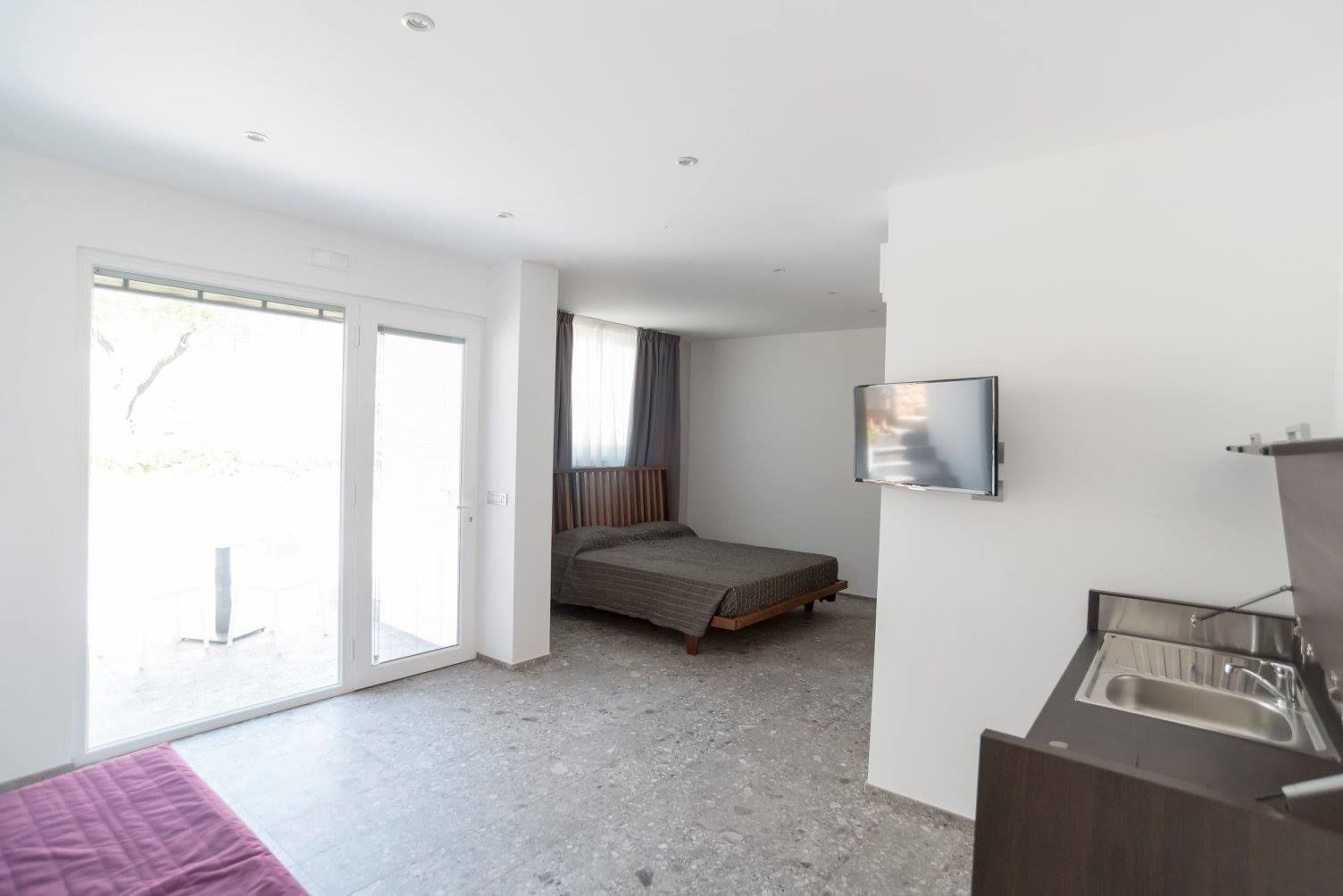 classic double room, kitchenette, patio | in-room safe, desk, soundproofing, cots/infant beds