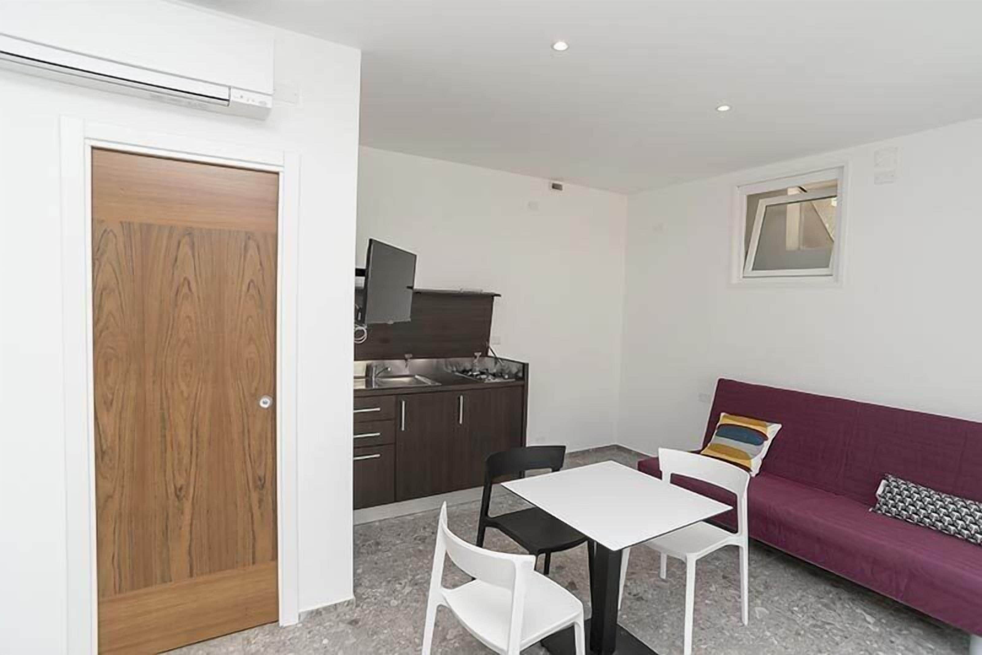 classic double room, kitchenette, patio | living area | flat-screen tv