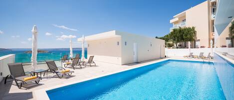 Seasonal outdoor pool, pool umbrellas, pool loungers