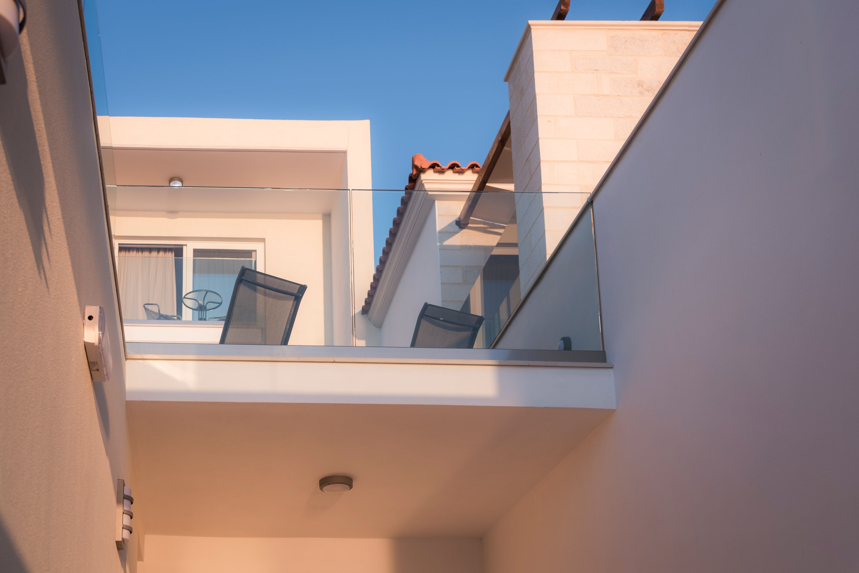 A modern building with a balcony, a window, and a door.