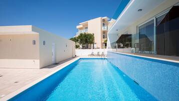 Seasonal outdoor pool, pool umbrellas, pool loungers