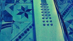 A bathroom with a modern design, featuring a shower with a control panel and a drain. The floor has a geometric tile pattern. - Palermo Central B&B (Palermo)