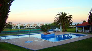 Outdoor pool, open 9:00 AM to 8:00 PM, pool umbrellas