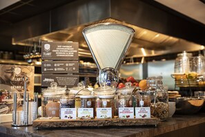 A display of various food items including granola, honey, and jams at a cafe. - Hotel 46 (Wintelre)