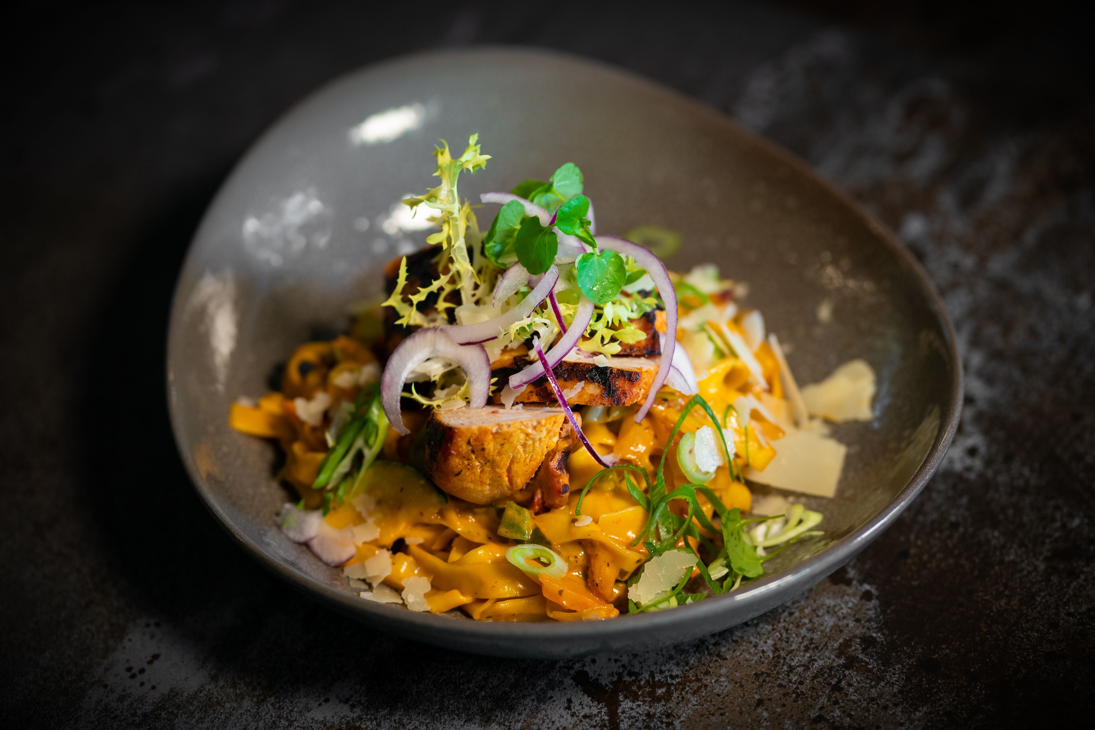 A bowl of food with various toppings and garnishes.