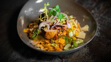 A bowl of food with various toppings and garnishes.