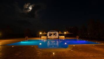 Seasonal outdoor pool, open 6:00 AM to 6:00 PM, pool umbrellas
