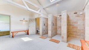 A spacious room with a high ceiling, stone walls, and a skylight. - Butley Barn (Woodbridge)