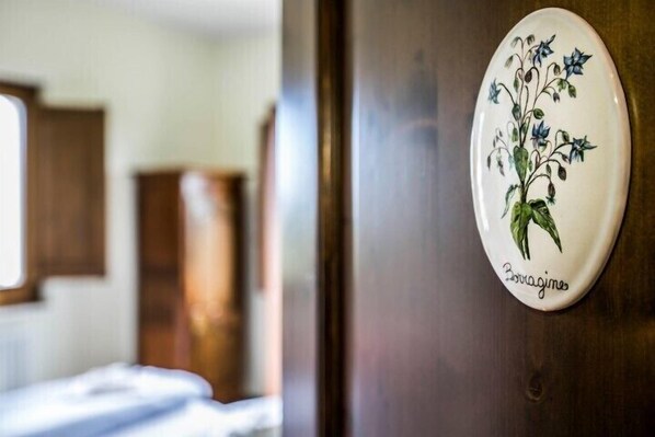 A door with a decorative plate featuring a plant design and the word "Bovagines."
