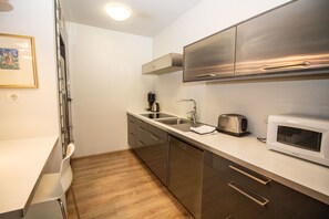 Deluxe Apartment, 1 Bedroom, Ground Floor | Living area | Flat-screen TV