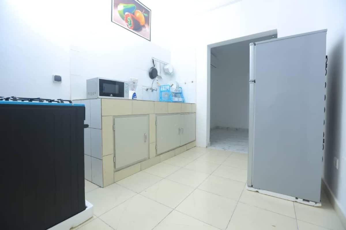 A kitchen with cabinets, a microwave, and a refrigerator.