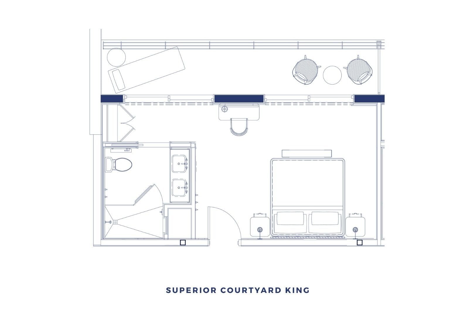 A floor plan of a Superior Courtyard King room with a kitchenette, a large bed, a desk, and a bathroom.