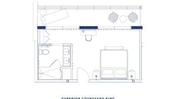 Grundriss eines Superior-Hof-Königszimmers mit Küchenzeile, großem Bett, Schreibtisch und Bad.