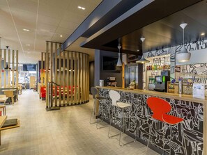 A modern bar area with a counter, seating, and a decorative wall. - ibis Parauapebas (Parauapebas)