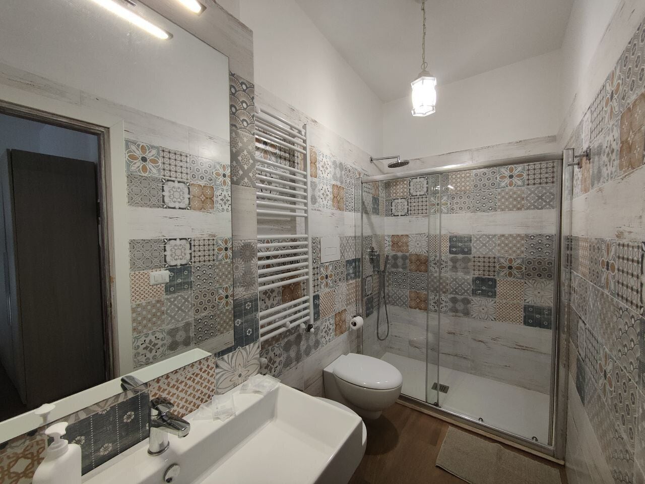 A bathroom with a shower, toilet, and sink.