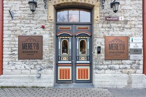 A double door with ornate designs and two signs on either side. - Stay Apartments - Near St Olav's Church (Tallinn)