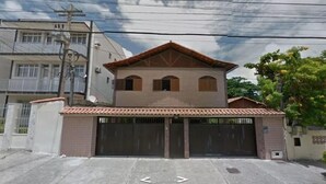 Una casa de dos pisos con techo de tejas y garaje.