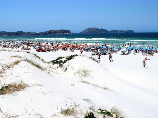 Playa en los alrededores, playa de arena blanca, camastros y sombrillas 