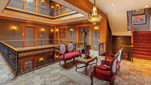 A spacious interior with a balcony, wooden furniture, and a chandelier. - Hotel Cruz del Vado by Art Hotels Ecuador (Cuenca)