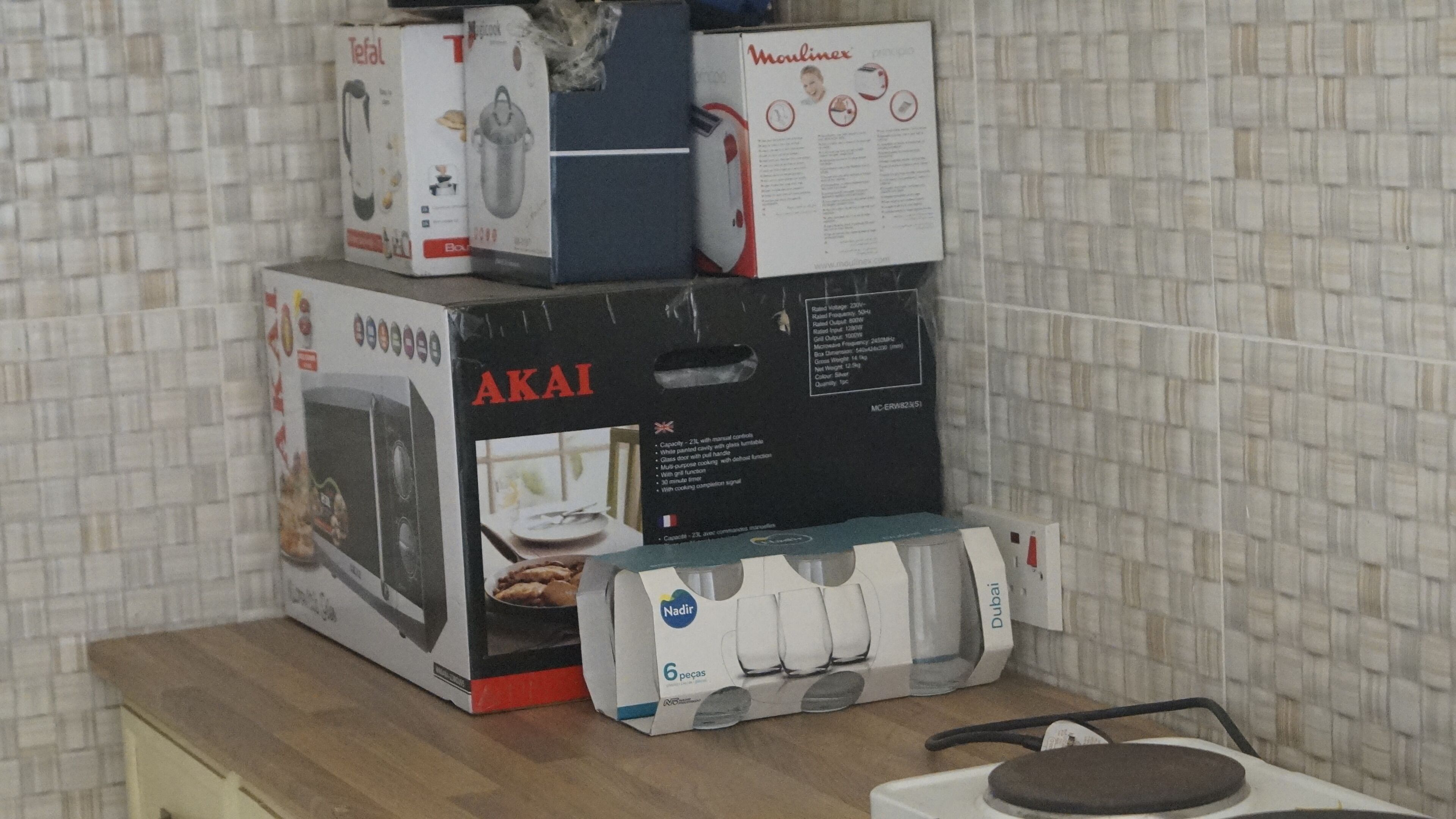 A stack of kitchen appliances on a wooden countertop.