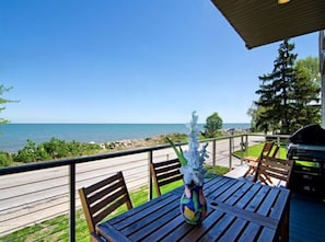 Front porch has a BBQ and an outdoor dining table