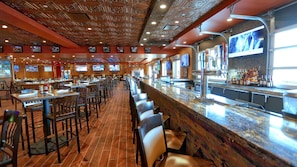 Enjoy dining at this restaurant with a long counter and multiple seating areas, featuring flat-screen TVs and a well-stocked bar.