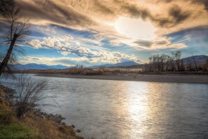 A river with a clear sky and mountains in the background. - Riverfront property with the best views in Paradise valley! (Livingston)