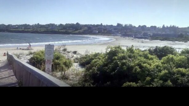 A coastal view with a beach, a boardwalk, and a sign indicating a no swimming area. - Charming & spacious beach home in Bonnet Shores, Narragansett (Narragansett)