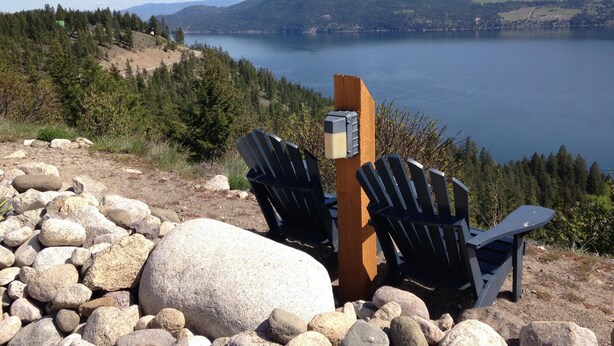 Two Adirondack chairs facing a lake with a wooden post and a mailbox in the foreground. - Bella Cottage @ La Casa Lakeside Resort, 180 Degree View Of Lake Okanagan. (Kelowna)