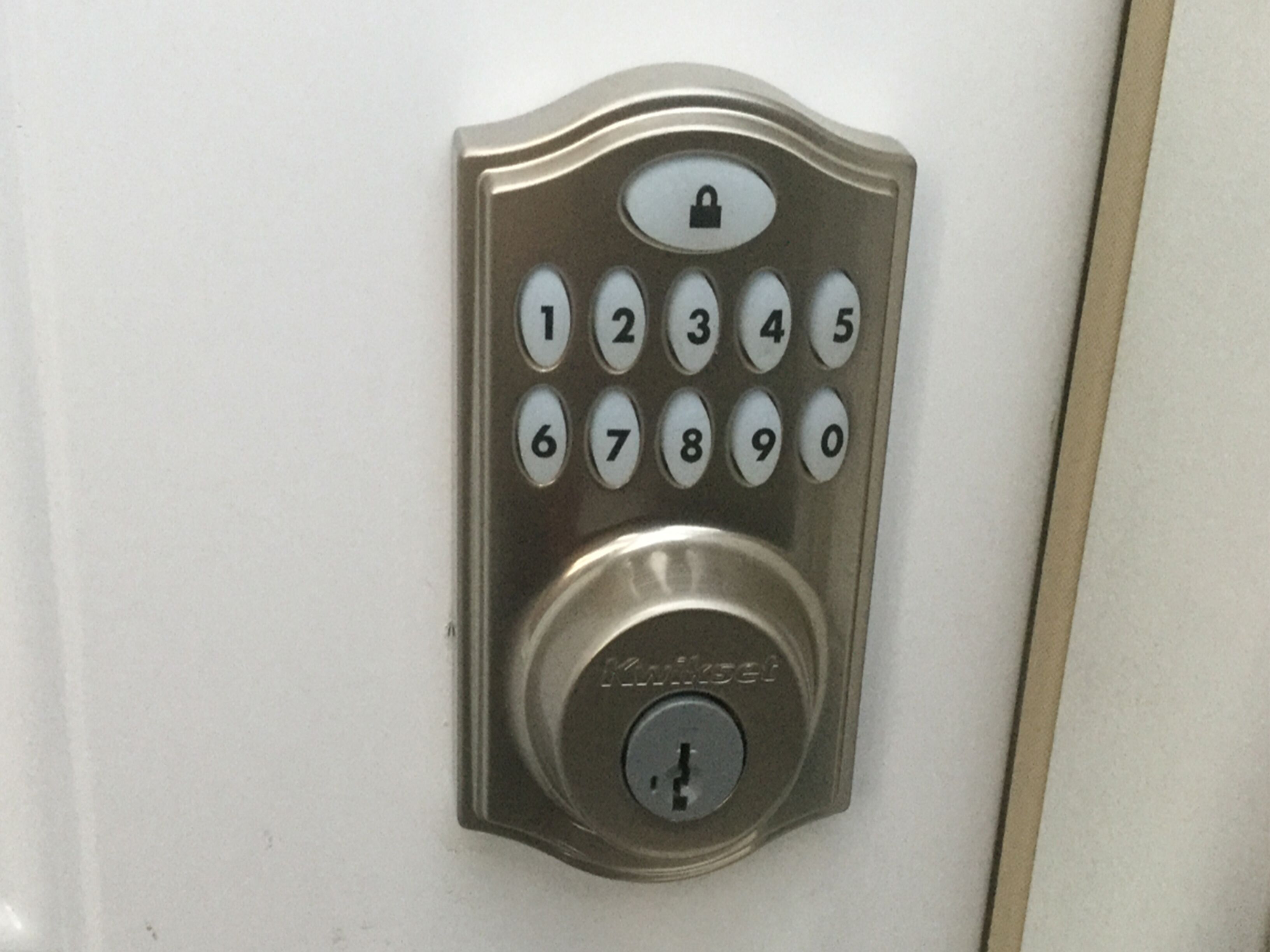 A keypad lock with a numeric keypad and a keyhole.