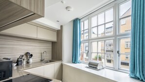 A modern kitchen with a window, a toaster, and a sink. - Cocoa Suites 45 - York city centre studio (sleeps 2) (York)