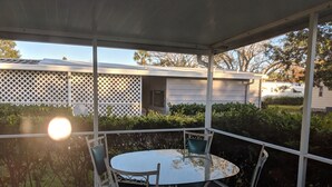 A covered patio with a round table and four chairs. - A few short Miles from siesta key (Sarasota)