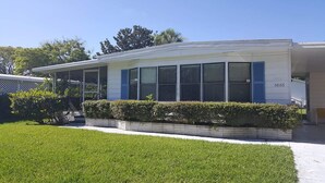 A modern two-story house with a covered porch, a well-maintained lawn, and a mailbox marked 5866. - A few short Miles from siesta key (Sarasota)