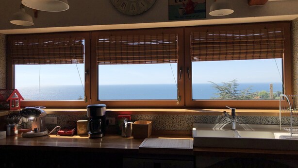 A kitchen with a view of the sea, a clock, and a 'Hot Coffee' sign. - ESPERIA, splendid sea view and immersed in the typical greenery of the Trieste Karst (Trieste)