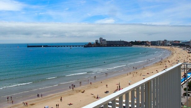 A coastal cityscape with a beach, a pier, and buildings in the background. - 2-Bedroom Apartment with Balcony in Sables-d'Olonne (Les Sables-d'Olonne)
