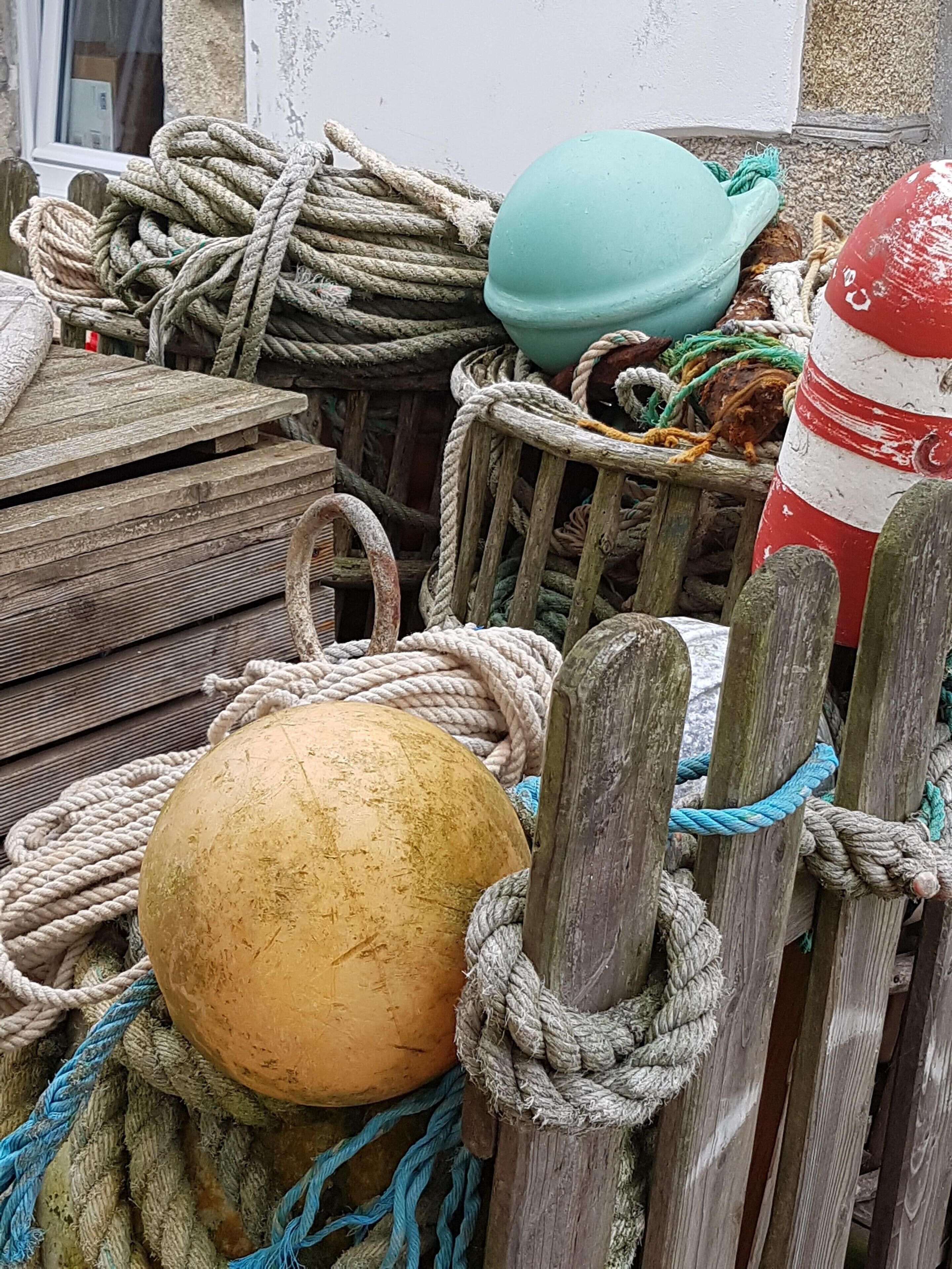 A collection of nautical equipment including buoys and ropes, suggesting a maritime or boating context.