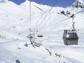 A cable car system in a snowy mountainous area.