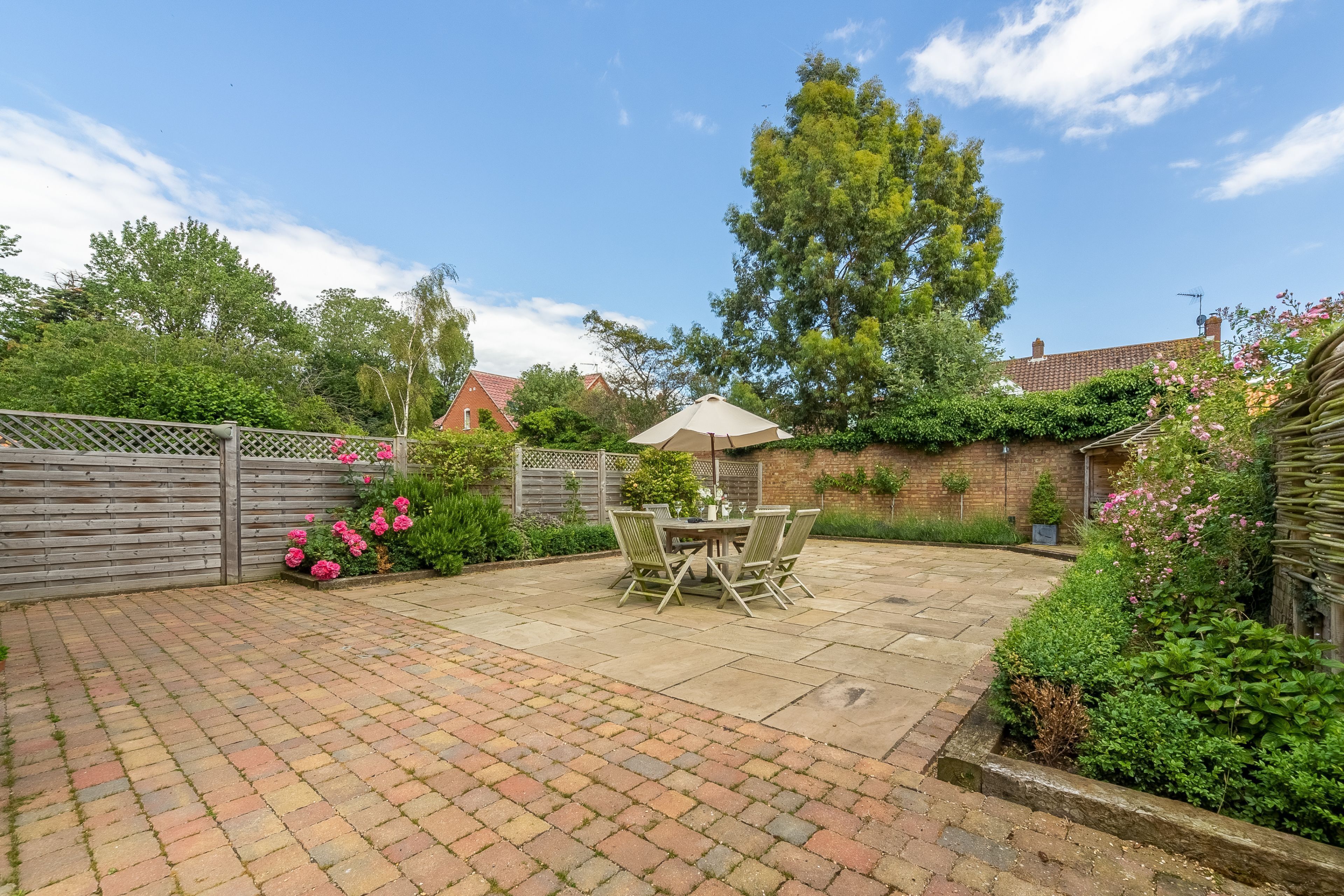 The rear garden is fully enclosed with a large terrace