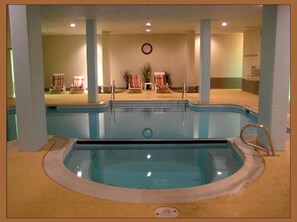 An indoor swimming pool with a hot tub, lounge chairs, and a clock on the wall. - March Deals - Silvercreek Lodge! 2BDR/2Bath. Ski In/Out, Wifi, Pool, Hot Tub (snowshoe)