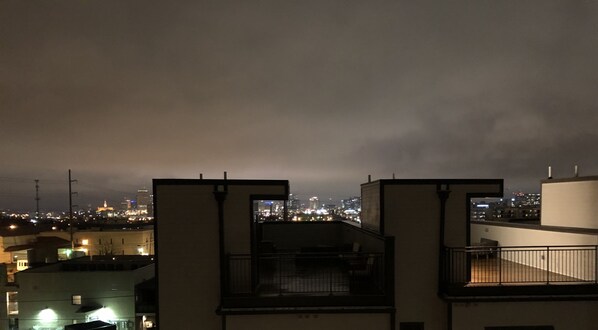 A nighttime cityscape with buildings and a cloudy sky. - Rooftop+Downtown close* Nashville mural* (Nashville)