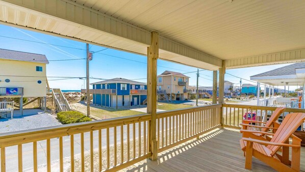 Enjoy the serene views of the beach and surrounding homes from this outdoor deck.