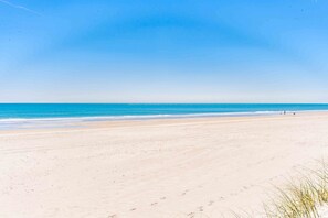 A beach with a clear sky and calm sea. - 75 Trips - 3BR 2nd Row Home - Covered Porch & Bonus Space; Dog Friendly! (Topsail Beach)