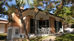 A two-story house with a covered patio area.